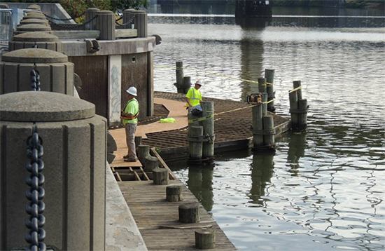 Workers restore the dock at Allegheny Landing
